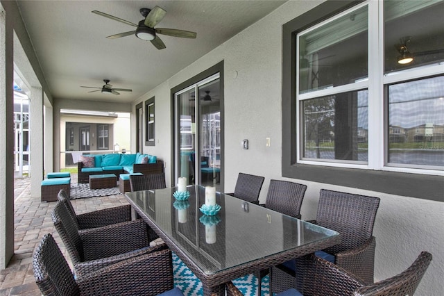 sunroom featuring ceiling fan