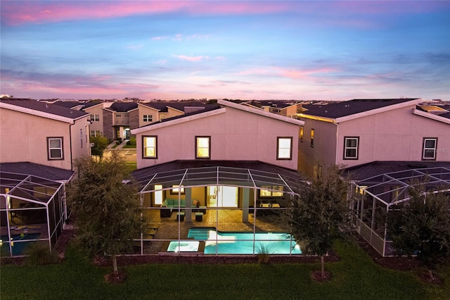 back house at dusk with glass enclosure