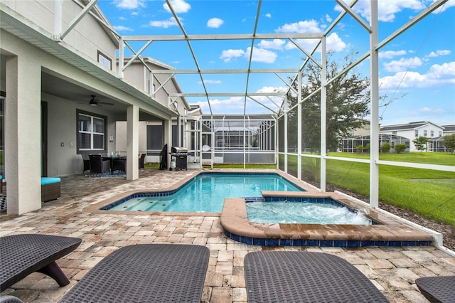 view of swimming pool featuring an in ground hot tub, a lanai, ceiling fan, grilling area, and a patio area