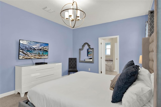 bedroom featuring ensuite bath, light carpet, and an inviting chandelier