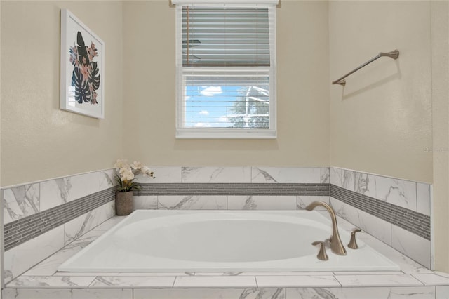 bathroom with a relaxing tiled tub