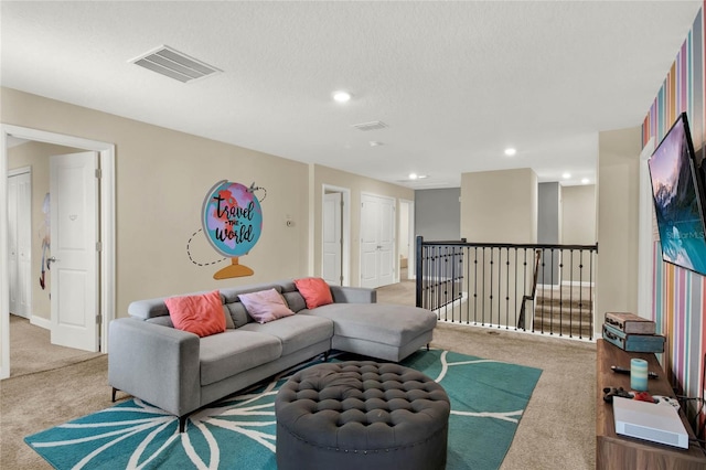 living room featuring a textured ceiling and light carpet