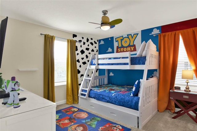 carpeted bedroom featuring ceiling fan and multiple windows