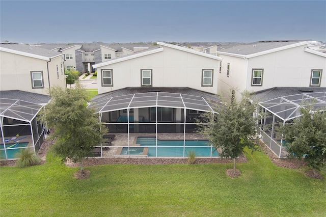 rear view of house featuring a lanai, a lawn, and a patio