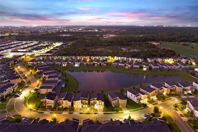 aerial view at dusk with a water view