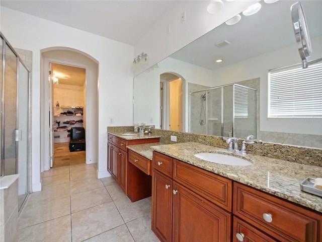 bathroom with vanity, a shower with shower door, and tile patterned flooring