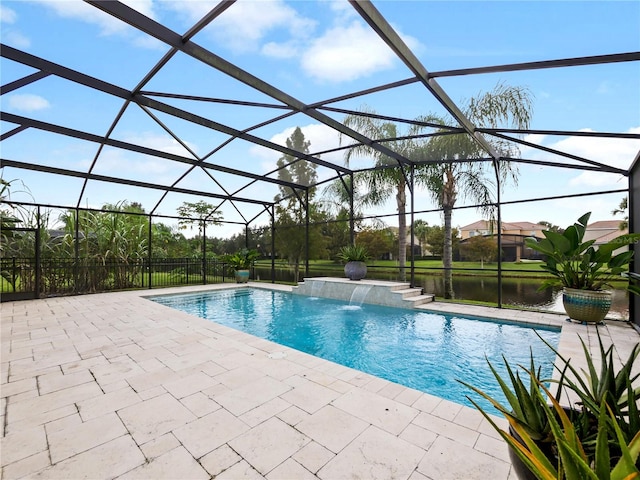 view of pool with a water view, glass enclosure, a patio, and pool water feature