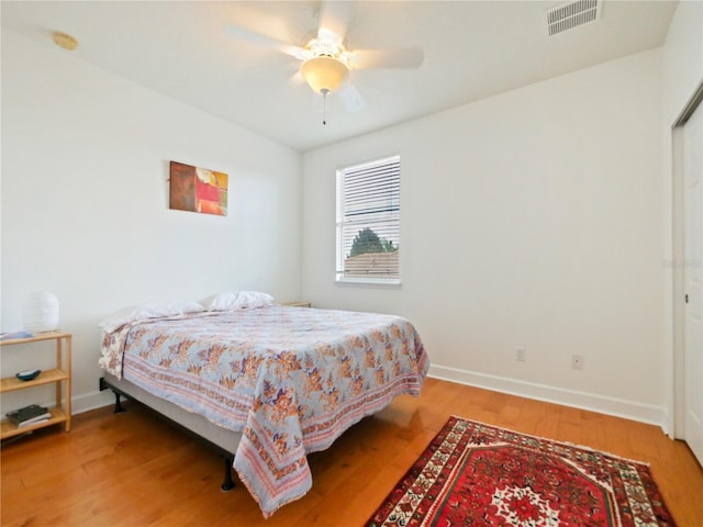 bedroom with ceiling fan and hardwood / wood-style floors