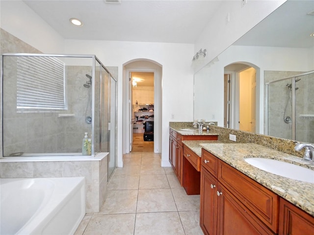 bathroom with shower with separate bathtub, tile patterned flooring, and vanity