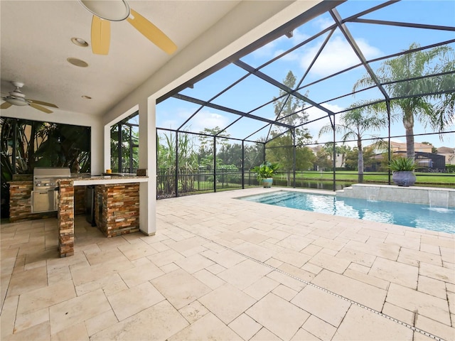 view of pool featuring pool water feature, a patio, glass enclosure, and ceiling fan