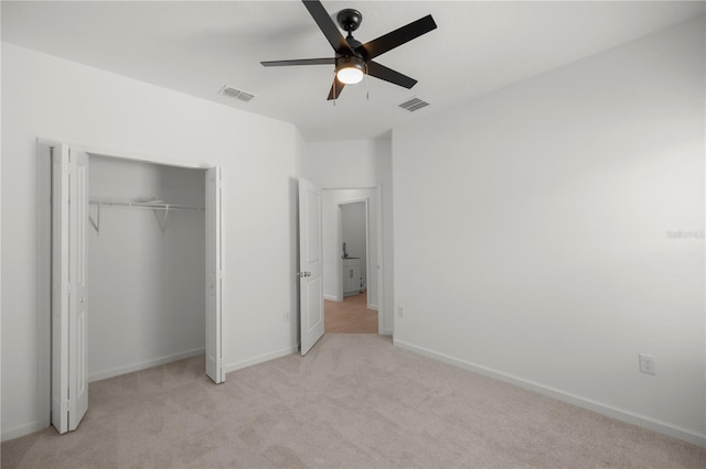 unfurnished bedroom with ceiling fan, a closet, and light carpet