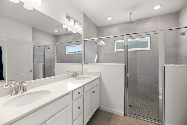 bathroom featuring wood-type flooring, an enclosed shower, and vanity