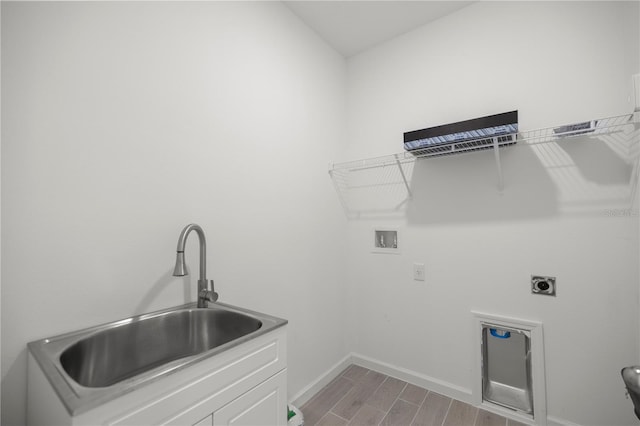 laundry room with hookup for an electric dryer, light hardwood / wood-style floors, sink, and washer hookup