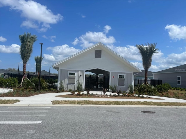 view of front of property with board and batten siding and fence