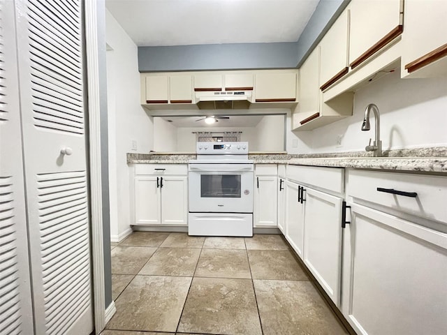 kitchen with white cabinetry, sink, and electric stove