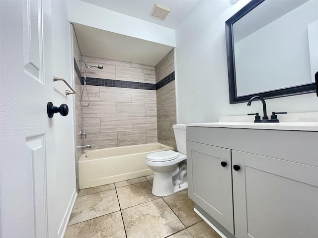 full bathroom featuring vanity, toilet, tiled shower / bath combo, and tile patterned flooring