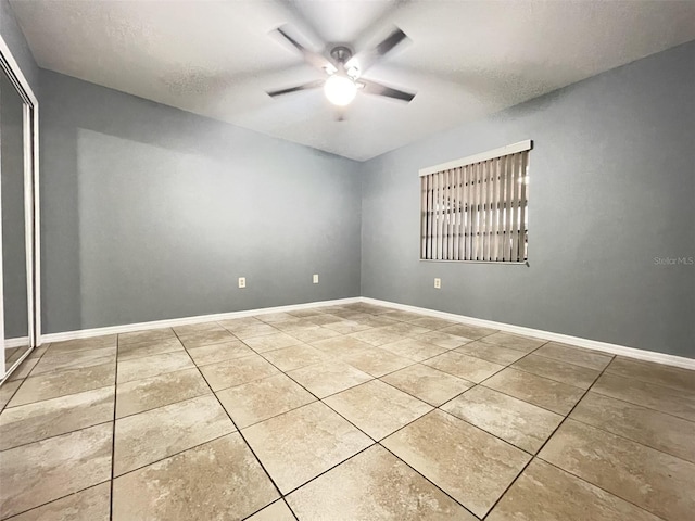 spare room featuring a textured ceiling and ceiling fan