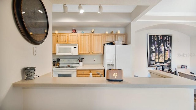 kitchen featuring white appliances, light brown cabinetry, and track lighting