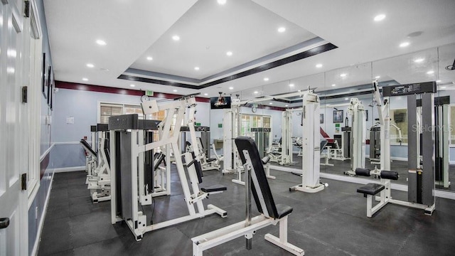 exercise room with a raised ceiling