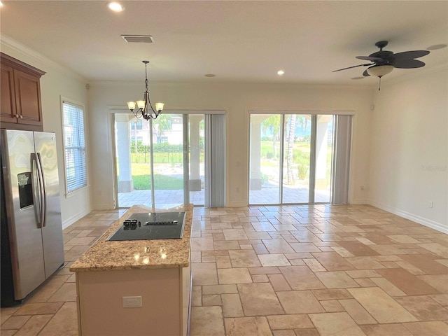 kitchen featuring pendant lighting, ornamental molding, stainless steel fridge with ice dispenser, black electric cooktop, and light stone countertops