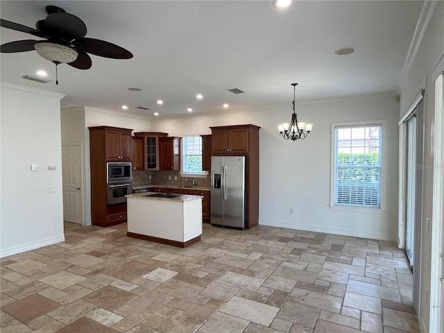 kitchen featuring a kitchen island, decorative backsplash, stainless steel appliances, decorative light fixtures, and ornamental molding