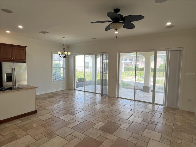 unfurnished living room with ceiling fan with notable chandelier, a healthy amount of sunlight, and crown molding