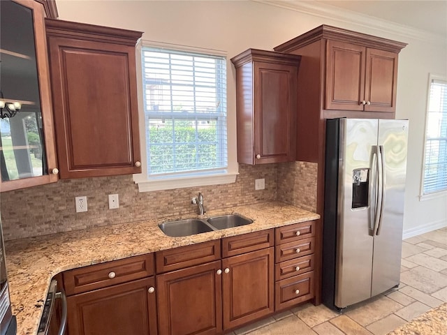 kitchen featuring appliances with stainless steel finishes, plenty of natural light, sink, and decorative backsplash