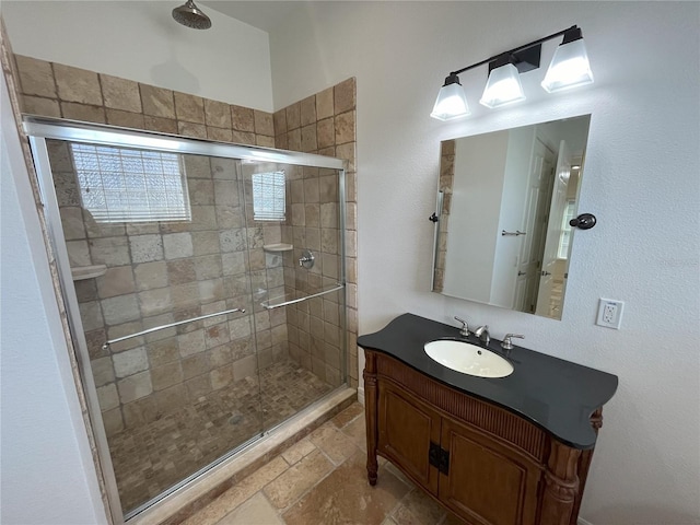 bathroom featuring vanity, toilet, and a shower with door