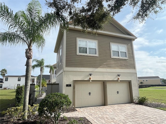 view of home's exterior featuring a garage and a yard