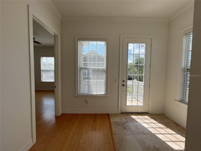 entryway with ceiling fan, light wood-type flooring, and crown molding