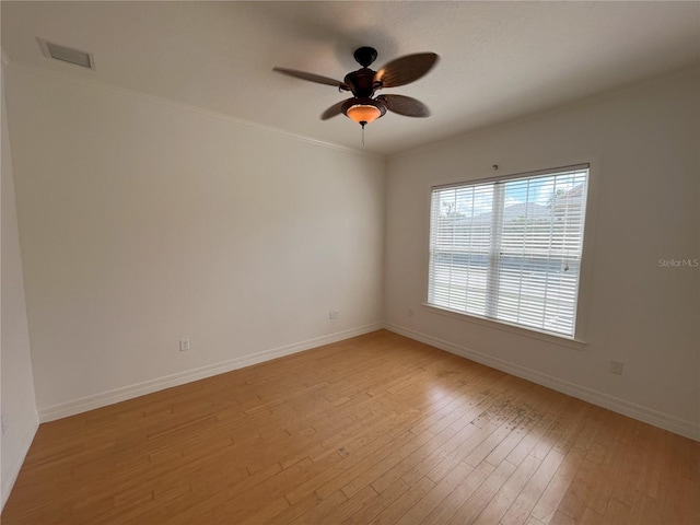 spare room featuring light hardwood / wood-style flooring and ceiling fan