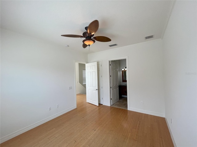 unfurnished bedroom featuring ornamental molding, light wood-type flooring, ceiling fan, and ensuite bathroom