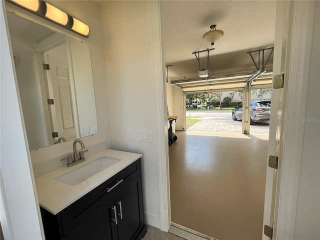 bathroom with a textured ceiling and vanity