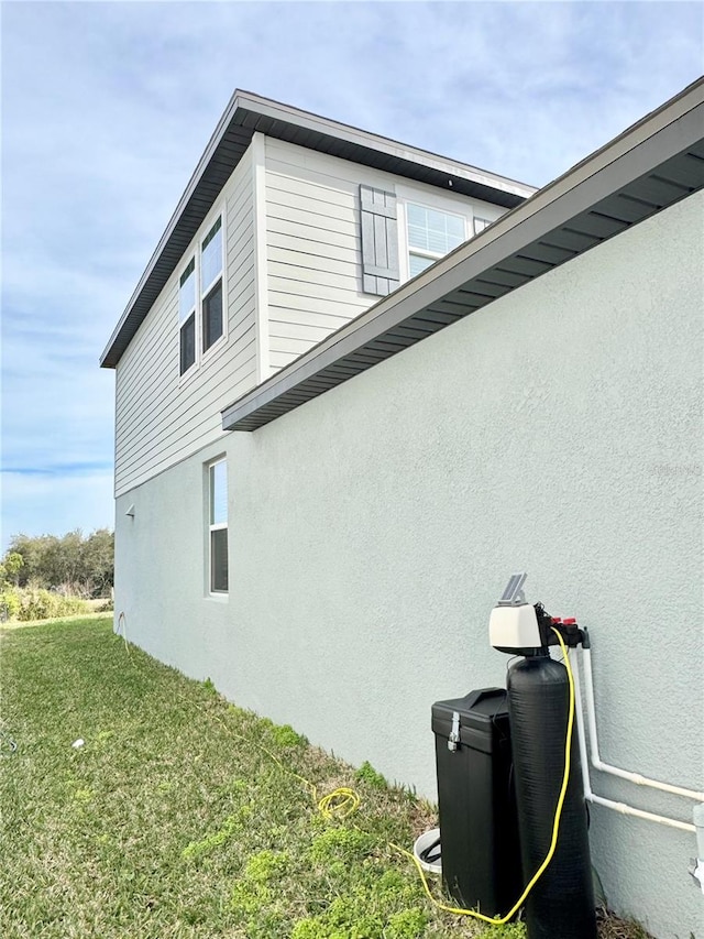 view of side of property with a lawn