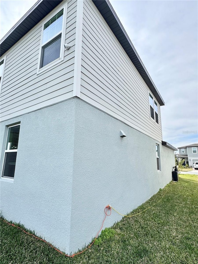 view of home's exterior with a lawn