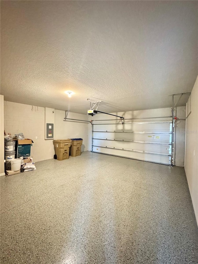 garage featuring a garage door opener and electric panel