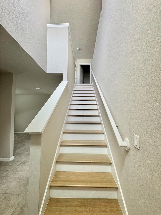 staircase with hardwood / wood-style floors