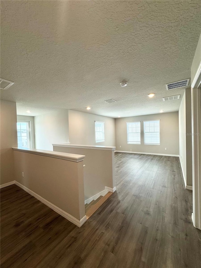 basement featuring dark hardwood / wood-style flooring and a healthy amount of sunlight