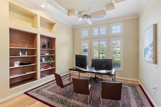 office space with ceiling fan, crown molding, hardwood / wood-style floors, and built in features