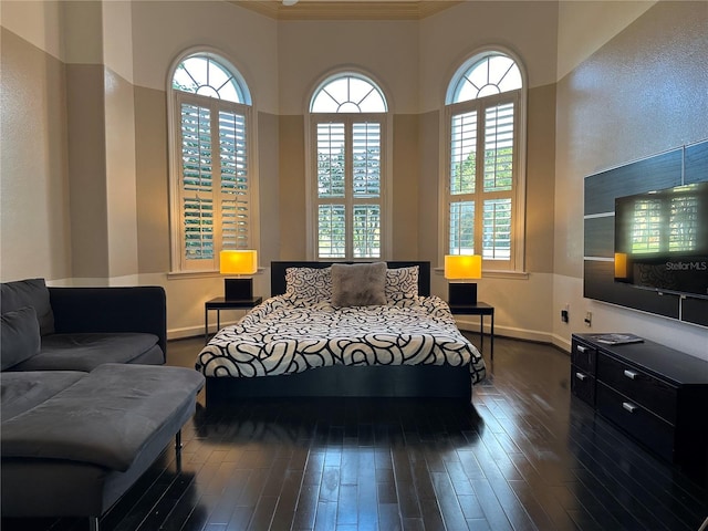 bedroom with crown molding and dark hardwood / wood-style flooring