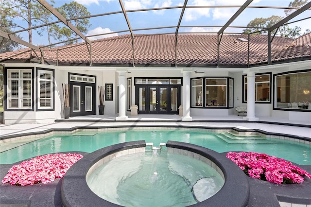 view of swimming pool with a patio, an in ground hot tub, and a lanai