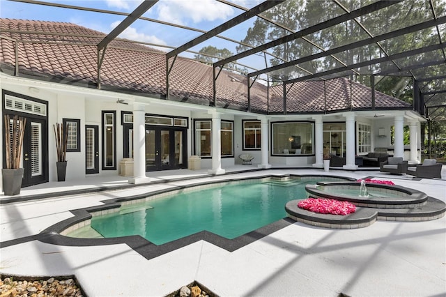 view of pool with an in ground hot tub, a patio, outdoor lounge area, french doors, and glass enclosure