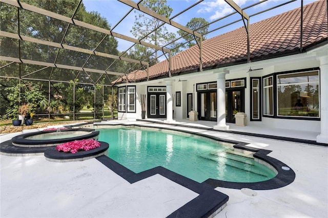 view of swimming pool with ceiling fan, glass enclosure, an in ground hot tub, and a patio area