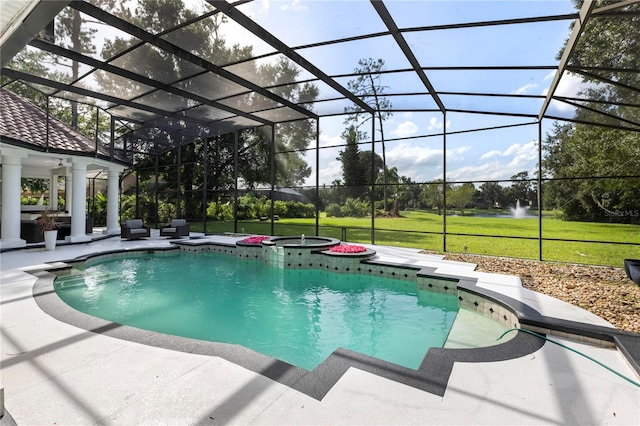 view of pool with an in ground hot tub, a yard, a lanai, and a patio area