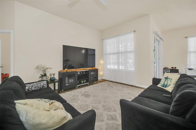 living room featuring light wood-type flooring and ceiling fan