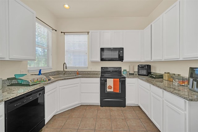 kitchen with white cabinetry, black appliances, sink, and light tile patterned flooring