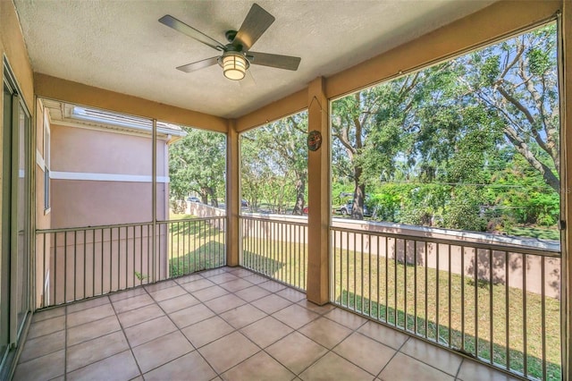 unfurnished sunroom featuring ceiling fan