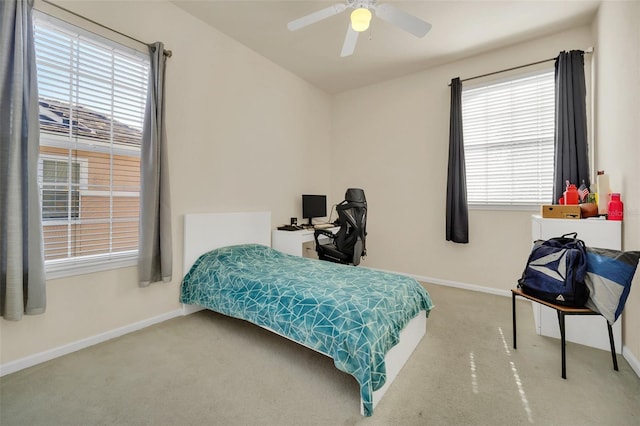 bedroom featuring ceiling fan, multiple windows, and carpet