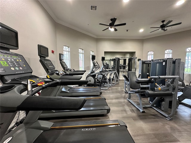 exercise room featuring visible vents, crown molding, ceiling fan, recessed lighting, and wood finished floors