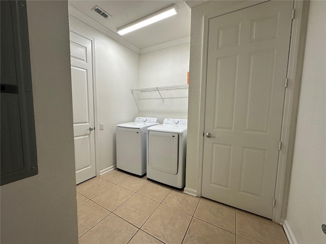 laundry area with visible vents, electric panel, light tile patterned floors, laundry area, and washing machine and clothes dryer